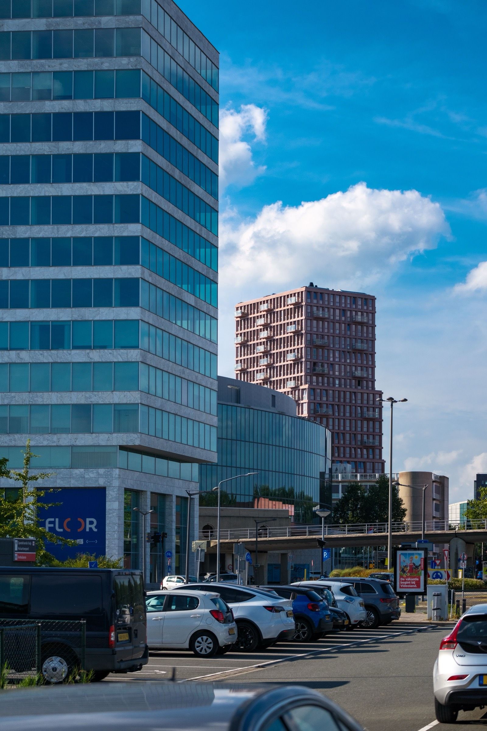Parkeerterrein met geparkeerde auto's bij kantoorgebouwen